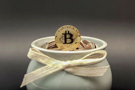 The bitcoin coin lies in the piggy bank on fiat coins. Cryptocurrency accumulation and investment symbol.