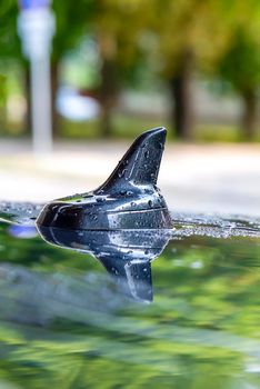 Car navigation antenna. GPS antenna on the roof of the car in the rain. Place for the text. Theme for advertising car electronics or auto electrics