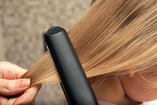 Hair straightening with an iron. Hairstyle at home.
