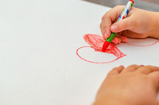 valentine's day, girl draws heart on paper, copy space.