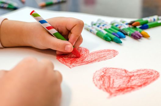 valentine's day, girl draws heart on paper, copy space.