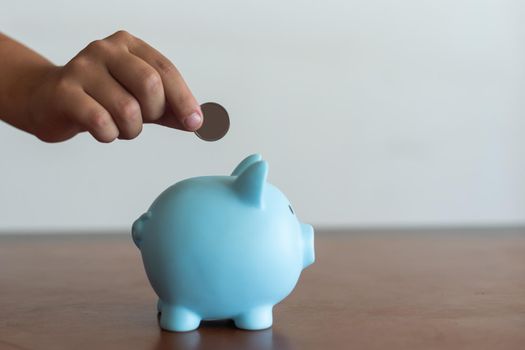 Pink piggy bank in the children's hands.