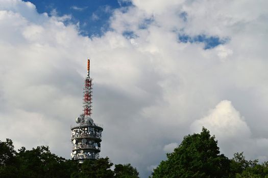 Large TV transmitter with satellite dishes and other antennas. Internet - wifi - mobile gsm signal. Concept for technology and industry. Brno - Hady.