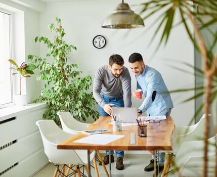 Portrait of two young business people having a meeting in the office. Teamwork and success concept