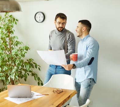 Portrait of two young business people having a meeting in the office. Teamwork and success concept