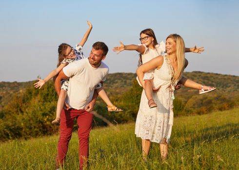 Portrait of a young happy family having fun outdoors