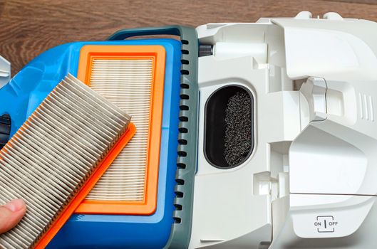 Vacuum cleaner filter with water filter. Large white vacuum cleaner on a brown floor
