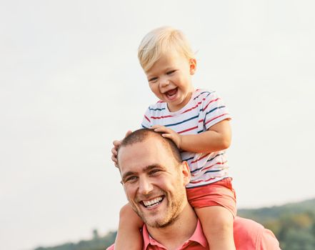 Portrait of a young happy family having fun outdoors