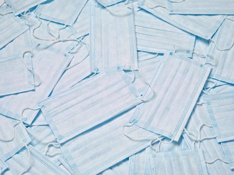 close up of a stack of protective masks on white background