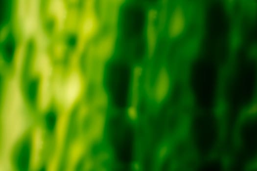 Acid abstract background in green tones. A soft blur of bright fluidity. Backdrop