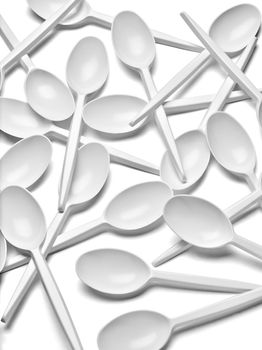 close up of a plastic cutlery spoons on white background