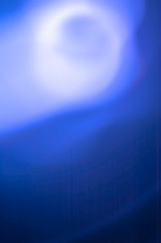 Vertical abstraction in blue tones, the light of the full moon in the fog.