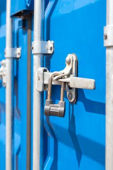 Container close-up. Blue cargo container with a lock. The concept of the increased cost of freight. Banner with place for text