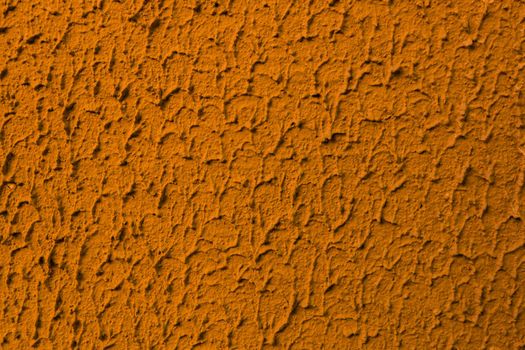 Abstract background of teracote plaster on the wall.