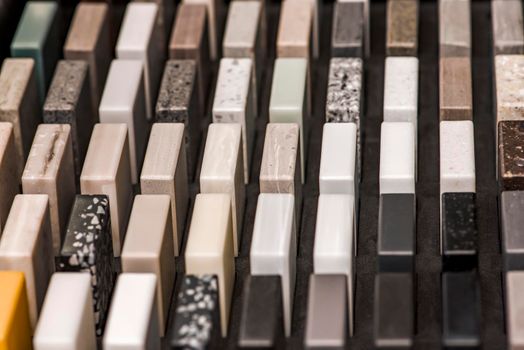 Samples of decorative artificial stone, close-up. Stone samples for kitchen countertops or bathroom, modern interior design.