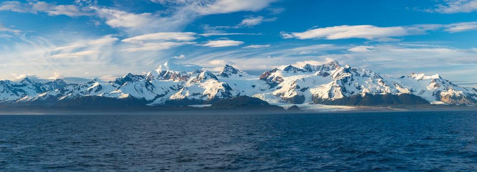 Late evening sun on panorama of mountains and Mount Fairweather by Glacier Bay National Park in Alaska