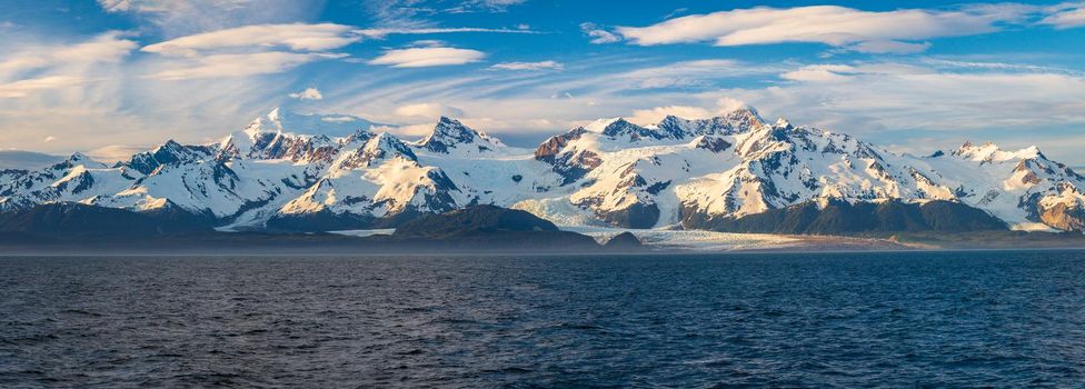 Late evening sun on panorama of mountains and Mount Fairweather by Glacier Bay National Park in Alaska