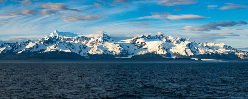 Late evening sun on panorama of mountains and Mount Fairweather by Glacier Bay National Park in Alaska