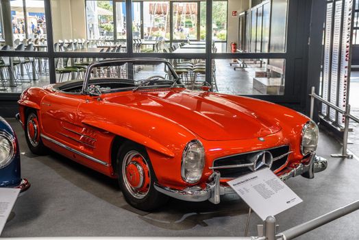 SINSHEIM, GERMANY - MAI 2022: red Mercedes Benz 300 SL roadster cabrio 1962 215ps