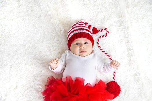 Baby dressed as Santa Claus. Christmas. Selective focus. People.