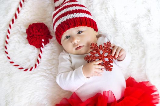 Baby dressed as Santa Claus. Christmas. Selective focus. People.