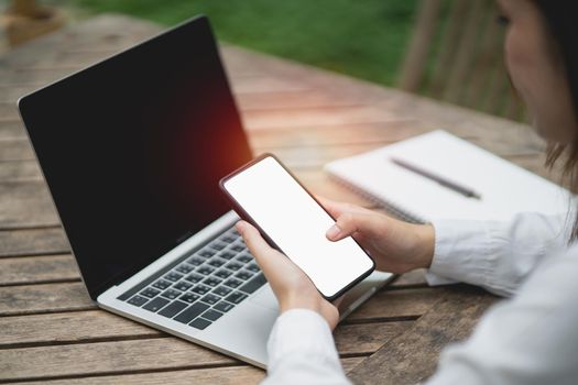 Asian woman hold mobile phone text or message white screen. Businesswoman use modern smartphone to browse web, read e-book, trade stocks.