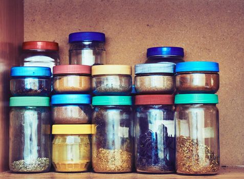 an aromatic or pungent vegetable substance used to flavor food, e.g. cloves, pepper, or cumin. spice storage containers. My various cooking spices in the kitchen cabinet