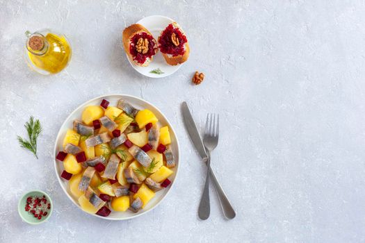 smoked hering, potato and beetroot salad served with beetroot caviar toasts, top view, copy space