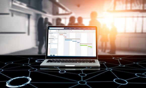 Project planning software for modish business project management on the computer screen showing timeline chart of the team project