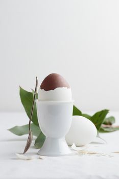 Chocolate egg on white eggstand holder with copy space
