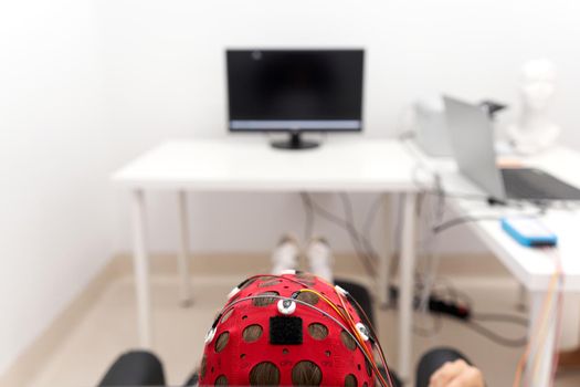 Focus on the headgear on a patient's while controlling the impulses during a biofeedback session