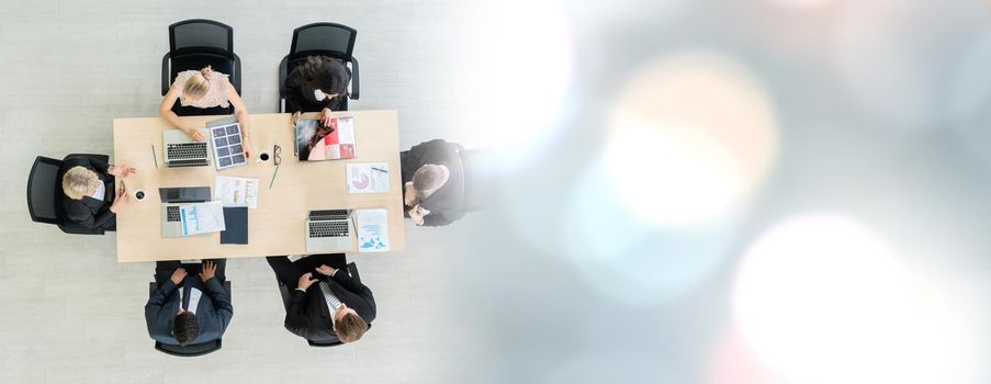 Business people group meeting shot from top widen view in office . Profession businesswomen, businessmen and office workers working in team conference with project planning document on meeting table .