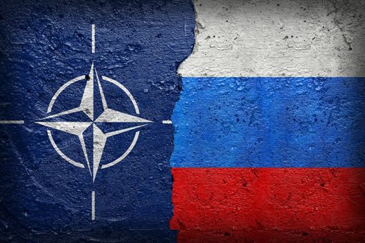 NATO vs Russia - North Atlantic Treaty Organization and Russian federation flag symobol on broken concrete wall background