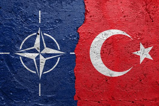 NATO and Turkey flags  - Cracked concrete wall painted with a North Atlantic Treaty Organization flag on the left and a Turkish flag on the right