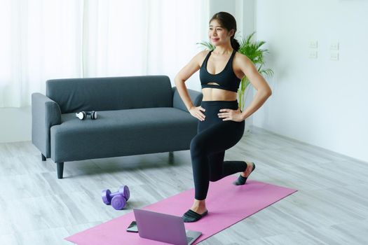 stress relief, muscle relaxation, breathing exercises, exercise, meditation, portrait of Young Asian woman relaxing her body from office work by practicing yoga by watching online tutorials