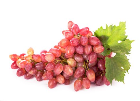 Ripe red grape with leaves isolated on white