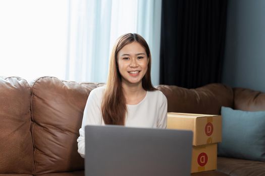 Portrait asian woman packing box. small business owner in home office, online sell marketing delivery, SME e-commerce telemarketing Startup small business entrepreneur concept.