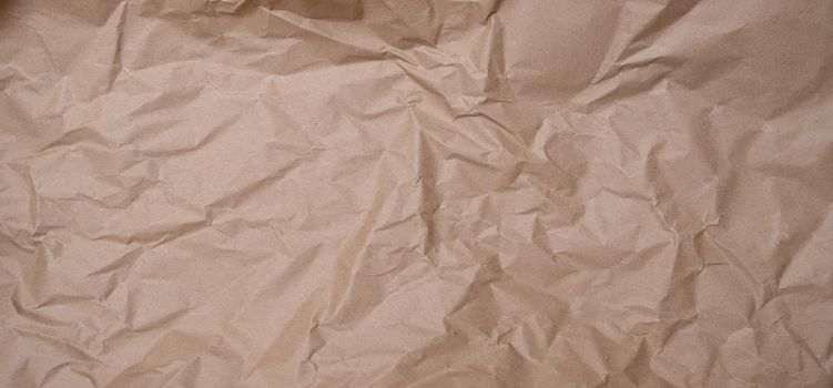 crumpled brown blank paper. Rumpled brown cardboard paper texture background