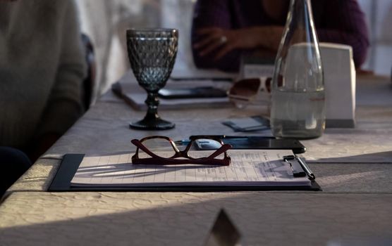 papers on table with water glass. business meet. Planning