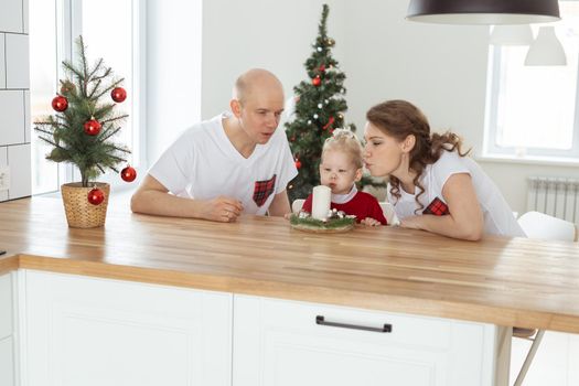 Baby child with hearing aid and cochlear implant having fun with parents in christmas room. Deaf and health