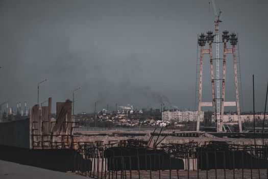 Industrial landscape of the city with smoke emissions from chimneys. Industry zone with building constructions.