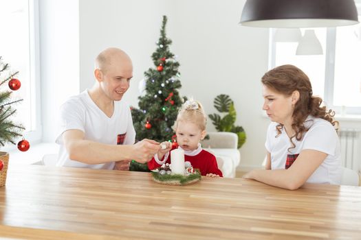 Child girl dressed in christmas dress with cochlear implants having fun at home - hearing aid and innovating technologies for treatment deafness