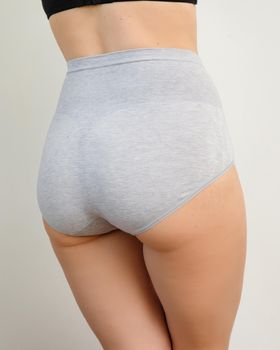 Close up portrait of a naked woman body in gray panties plus size, comfortable underwear