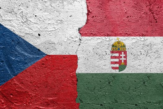 Czech Republic and Hungary - Cracked concrete wall painted with a Czech flag on the left and a Hungary flag on the right