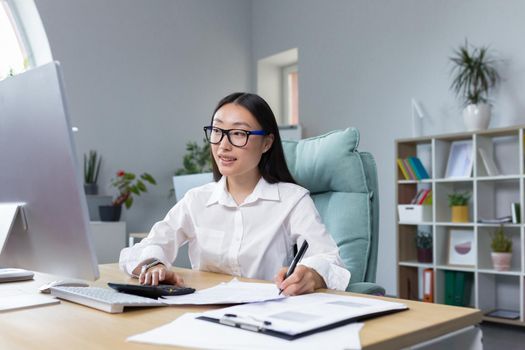 Serious thoughtful and confident woman working in office, asian worker businesswoman behind paper work.