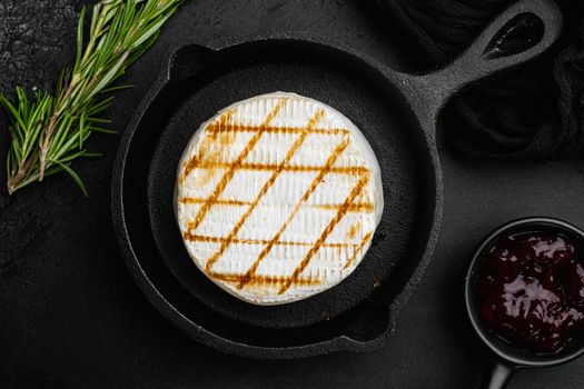Oven Backed camembert, on black dark stone table background, top view flat lay