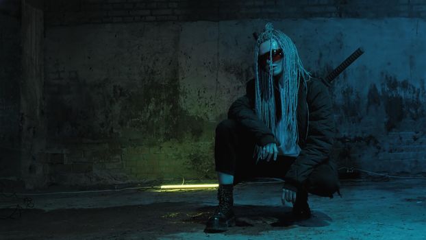 girl with dreadlocks and katanas in red glasses posing against a neon brick wall 4k
