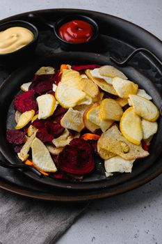 Dried vegetables chips set, on gray stone table background