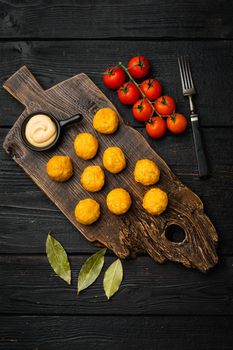 Battered meat, on black wooden table background, top view flat lay