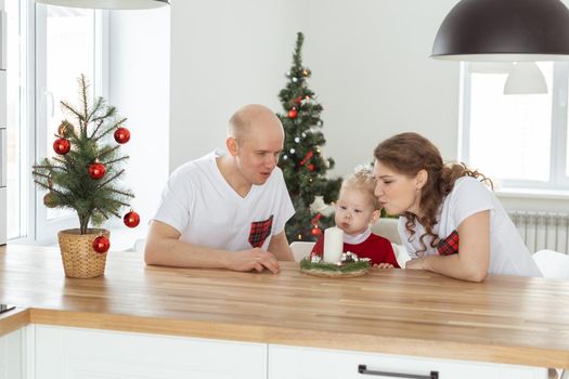 Baby child with hearing aid and cochlear implant having fun with parents in christmas room. Deaf and health